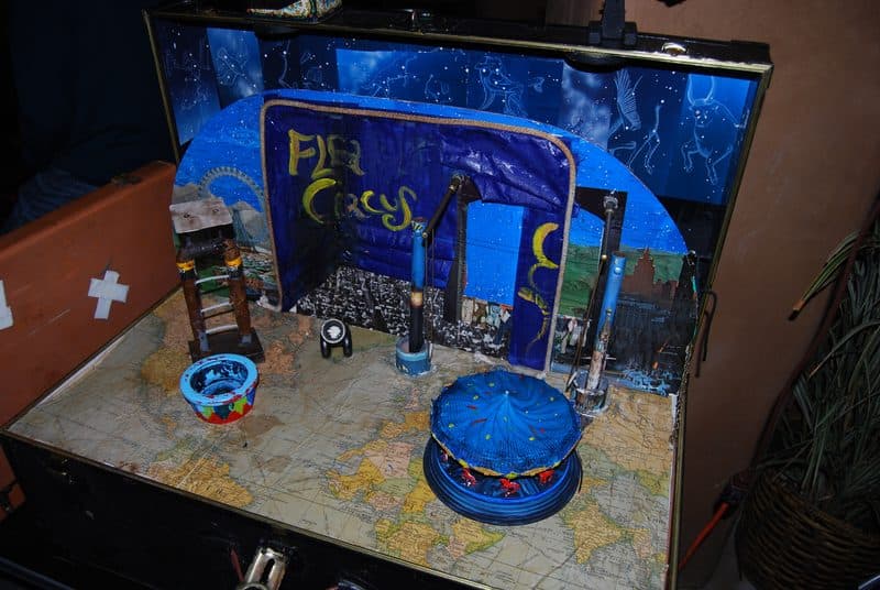 A modern flea circus presented inside a decorated suitcase